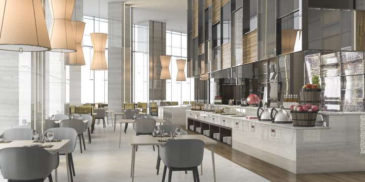Elegant commercial dining space featuring herringbone-patterned flooring, gray upholstered chairs, marble buffet counter with fruit baskets and covered dishes, and tall beige pendant lights. Large windows and mirrored walls create an airy, upscale ambiance.